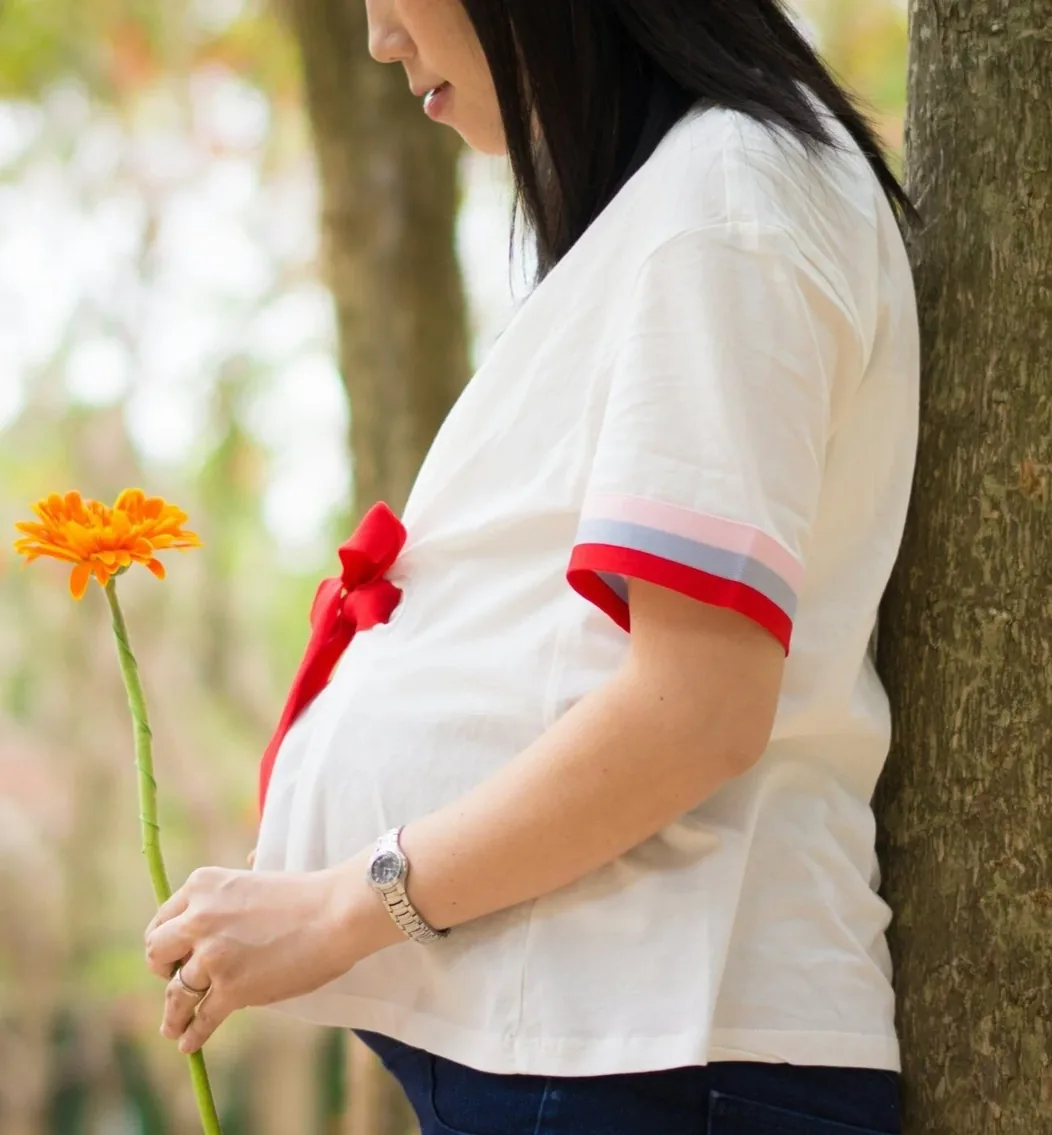 A parent holding a single flower